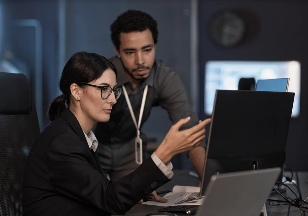 Two colleagues working on a computer.